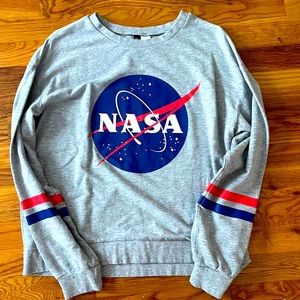 Comfy long sleeve NASA crewneck with a red and blue stripe on the sleeves.